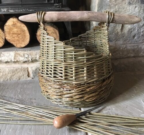 Handwoven almond leaved willow basket with driftwood handle. Handwoven almond leaved willow basket with driftwood handle.