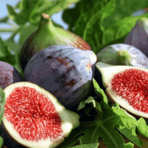 Six Black Mission Fig plump fruits, with one cut in half to reveal lovely, deep pink flesh.