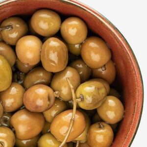 Olea Europaea Arbequina olives brined and in a bowl.
