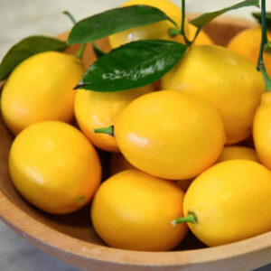 Yellow Meyer Lemon tree fruits in a bowl.