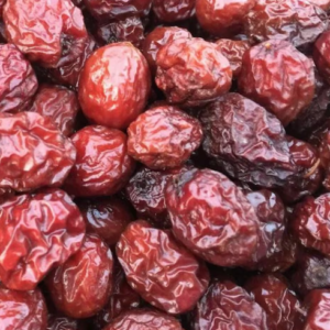 Empress gee jujube cut fruit with creamy white centre and brown and yellow mottled skin.