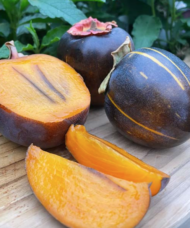 Kaki Persimmon with a dark skin and a yellowy orange flesh with dark stripes.