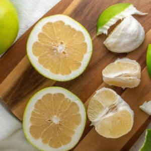 Melogold Grapefruit Tree fruit cut in half to reveal mellow gold flesh.